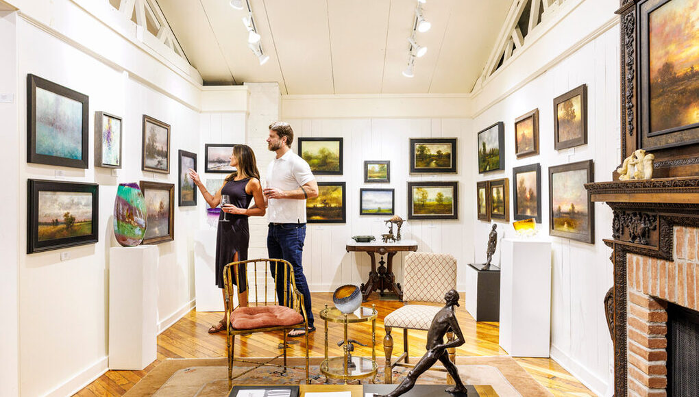 Guests viewing artwork in an Art Coast gallery