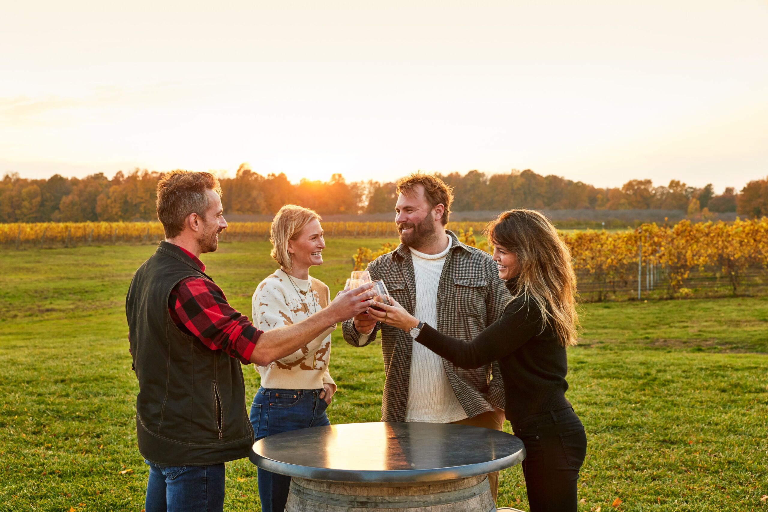 Four friends toasting over drinks.