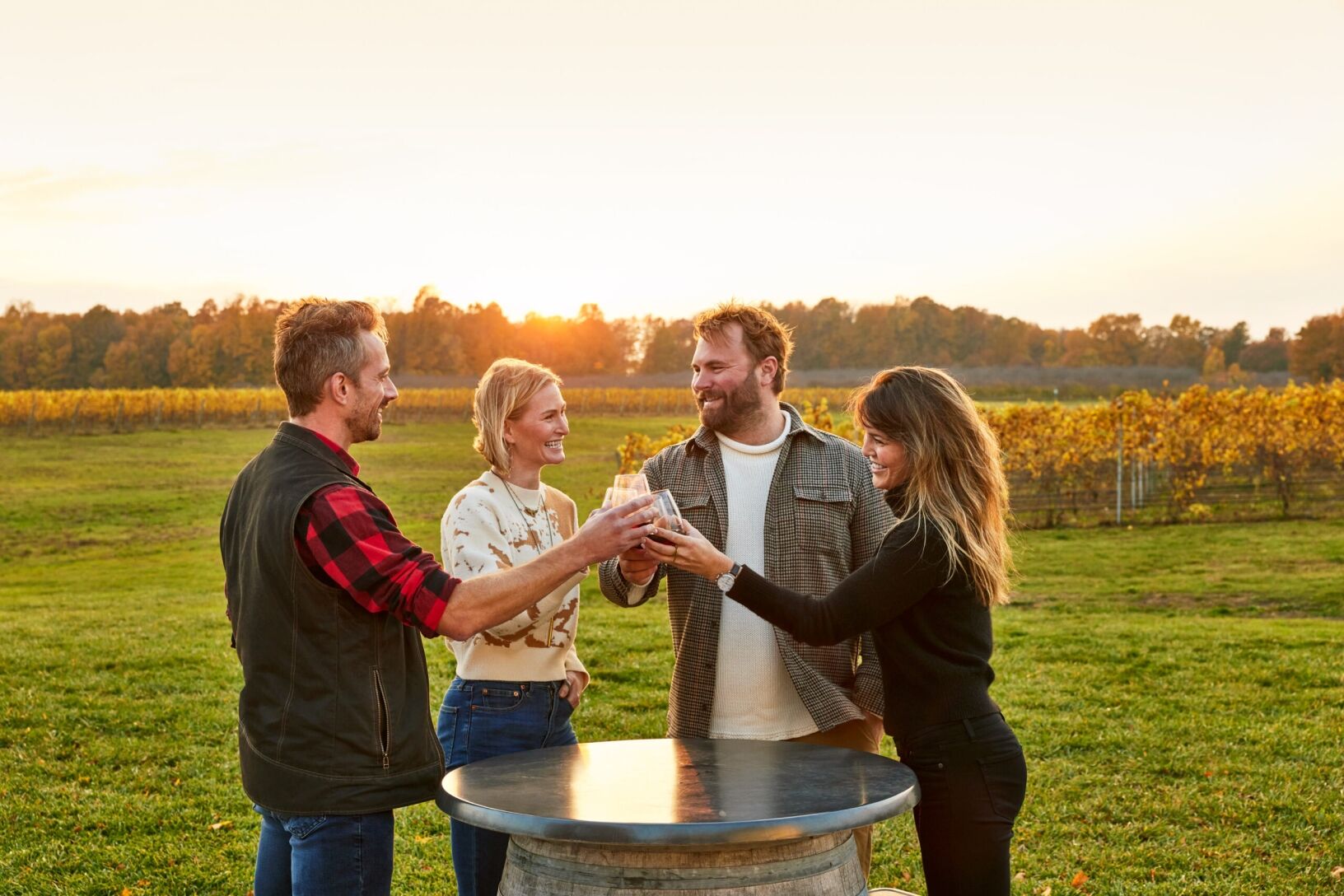 Four friends toasting over drinks.