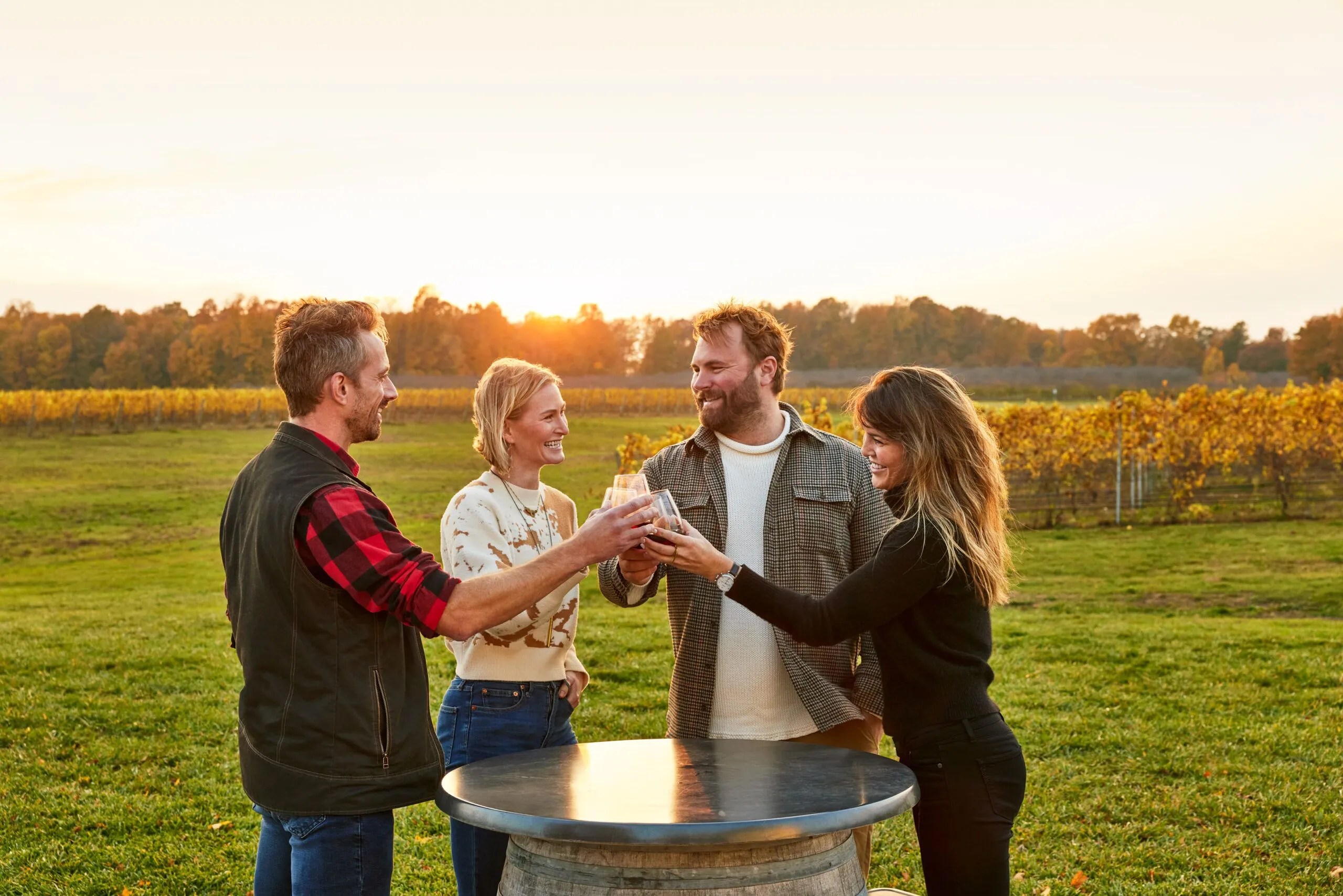 Four friends toasting over drinks.
