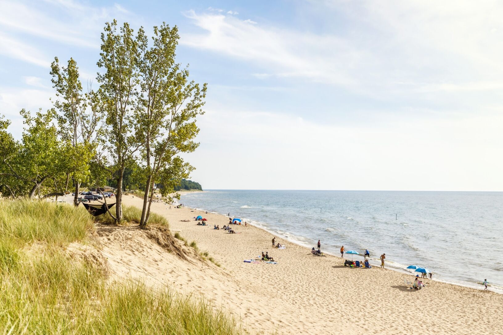 People relaxing on the shoreline of Oval Beach.