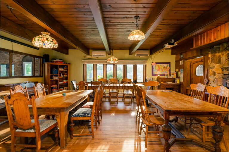 Dining room inside the Hop & Vine Inn showing 3 of the 4 tables with chairs.
