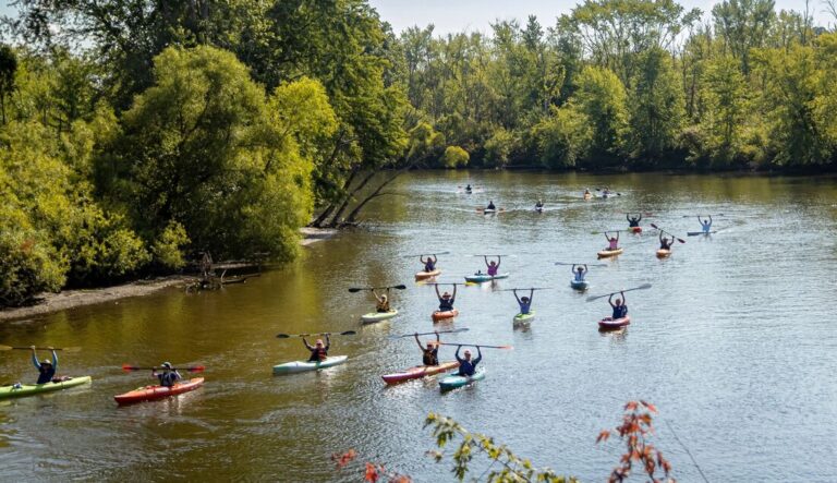 People kayaking down the Kalamazoo River.