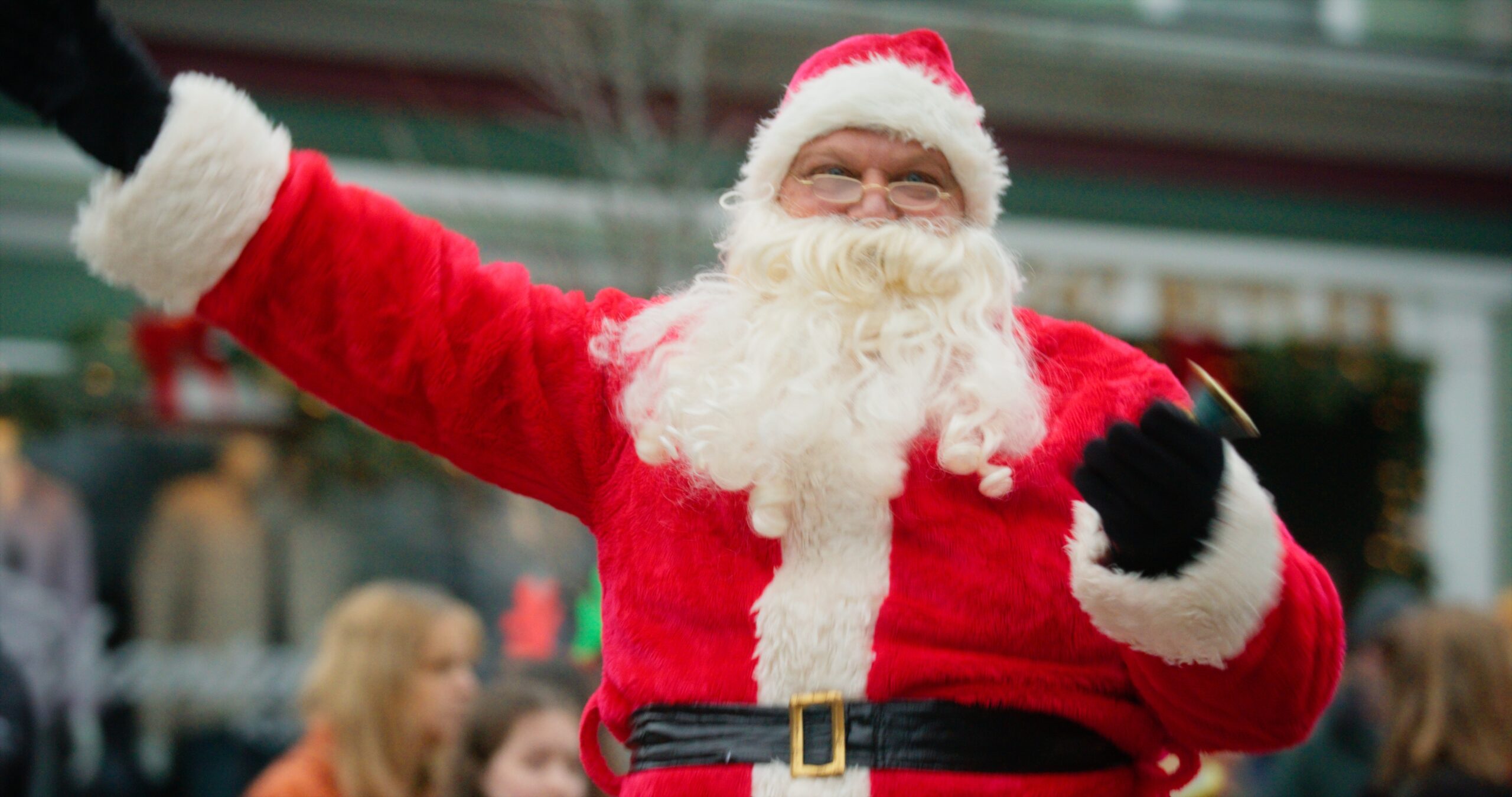 A man dressed as Santa waving in the Saugatuck Christmas Parade.