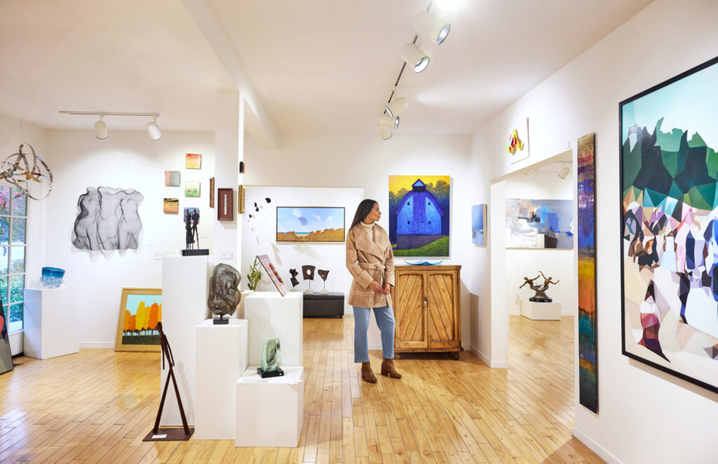 A woman browsing art at Water Street Gallery in Douglas.