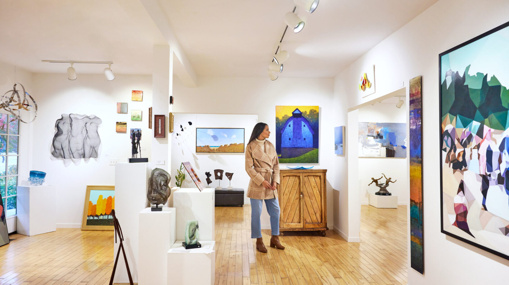 A woman browsing art at Water Street Gallery in Douglas.