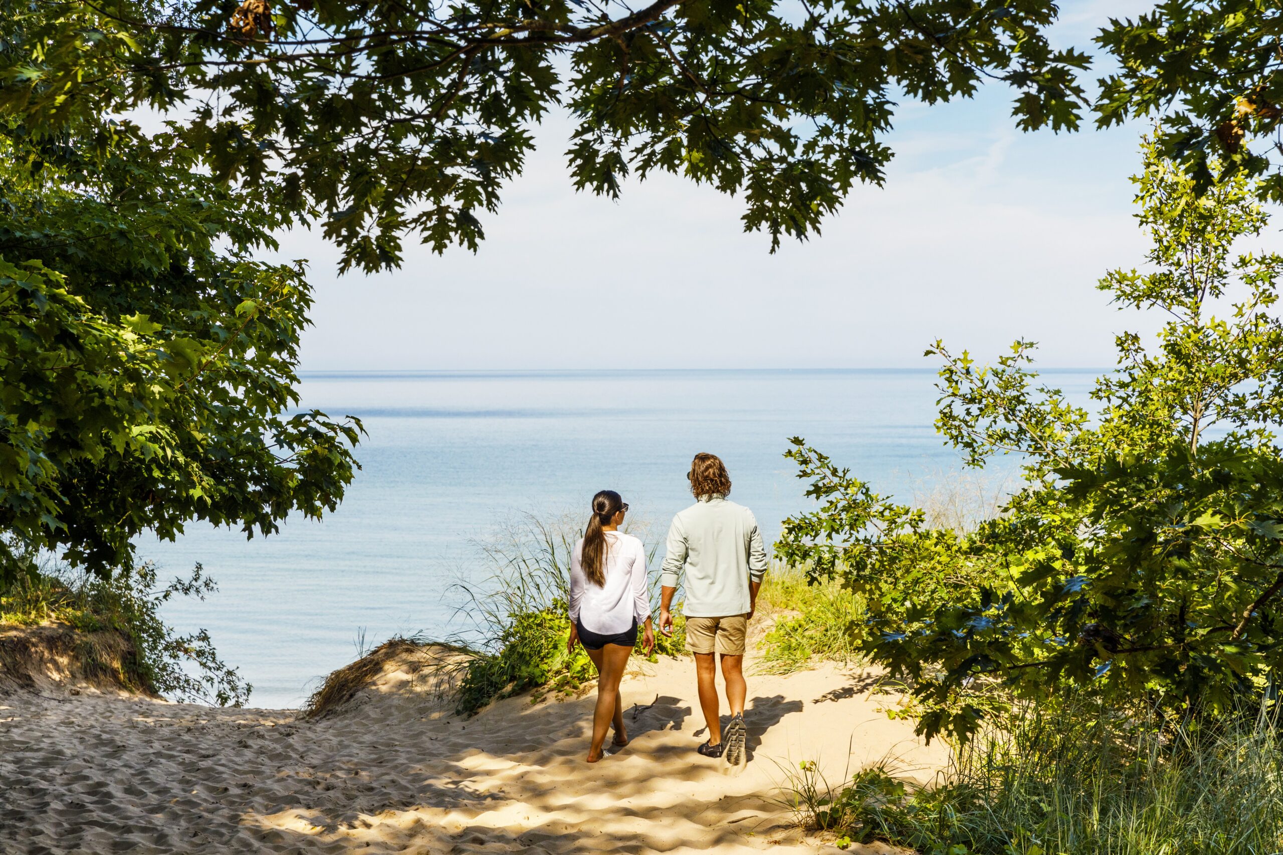 Couple standing on dune overlooking Lake Michigan