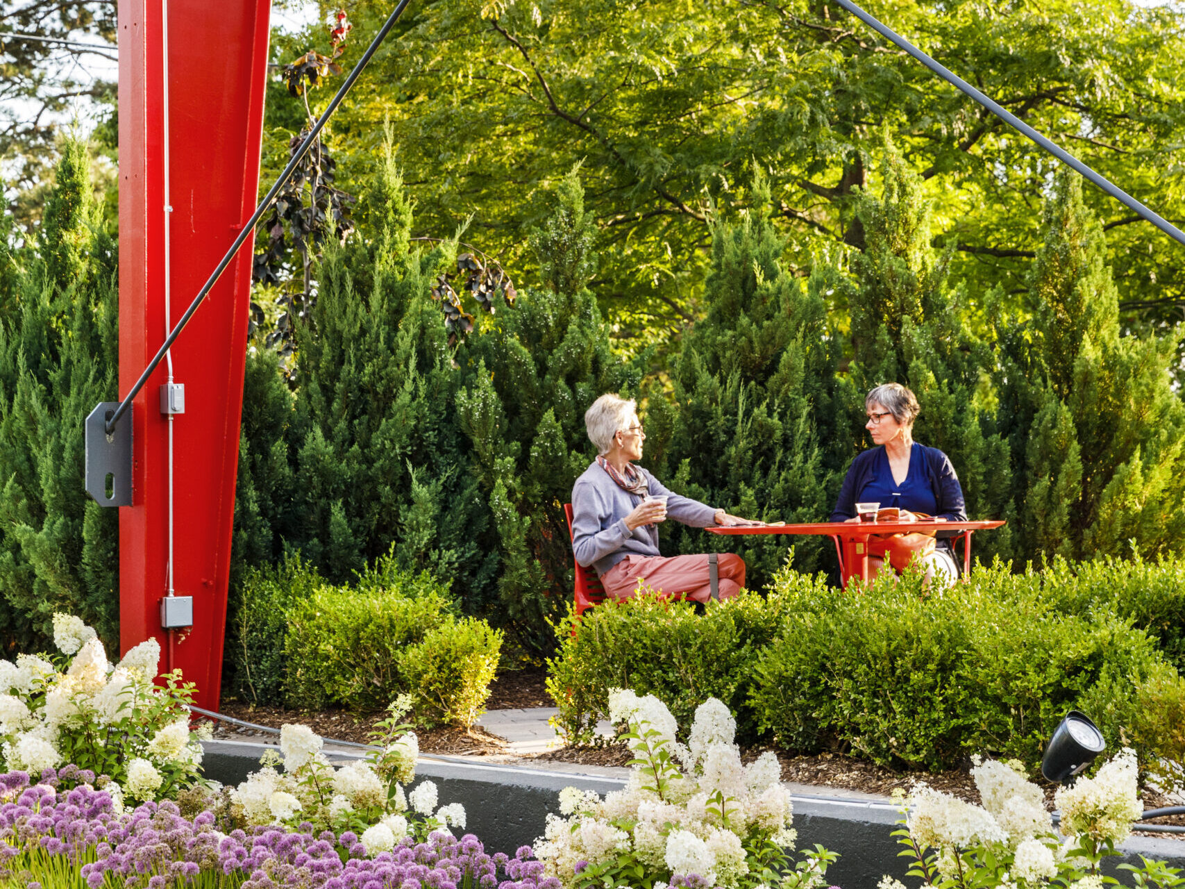 Two women sitting outside of the Saugatuck Center for the Arts.