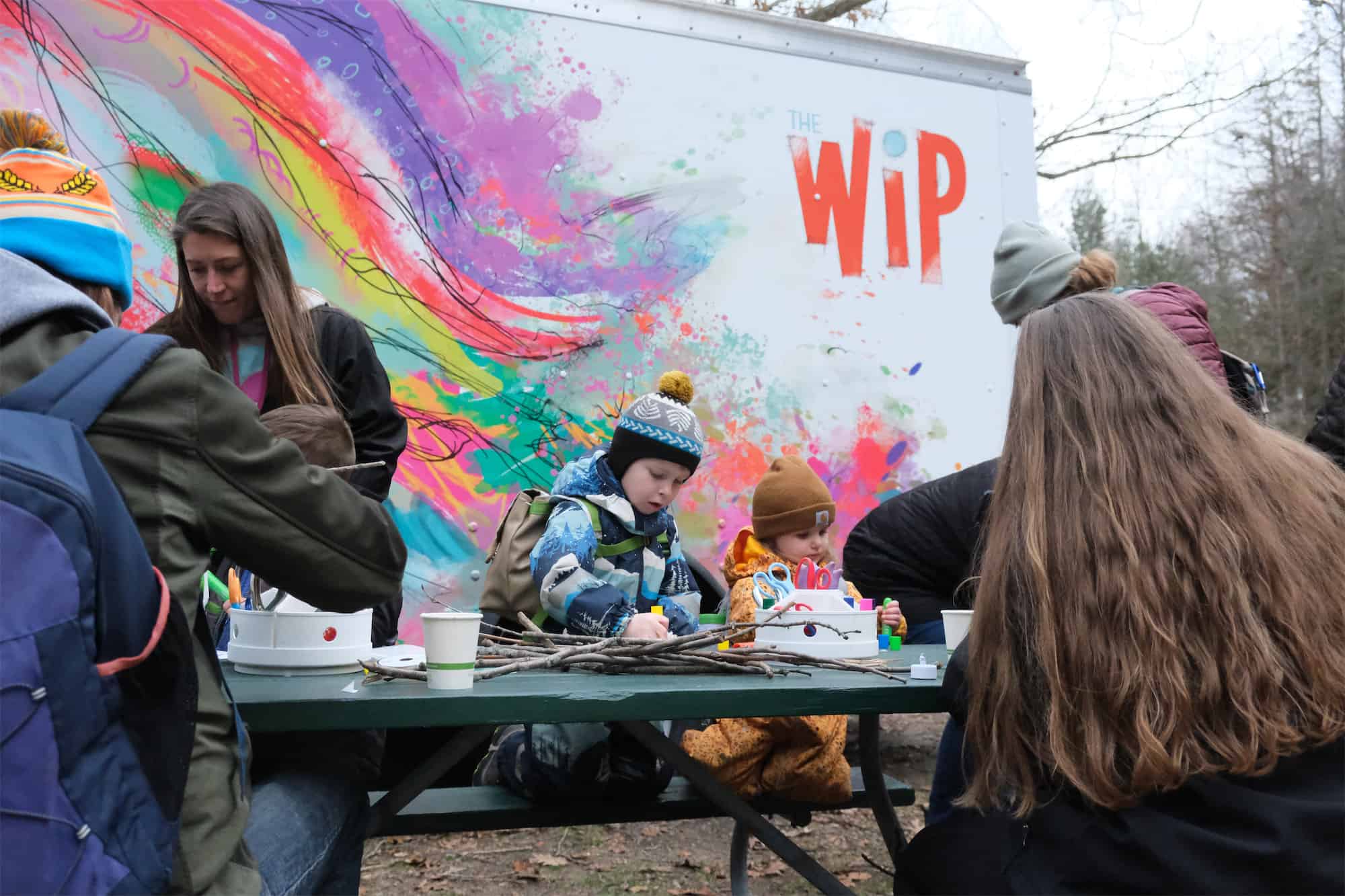 Kids at table in front of the mobile art truck