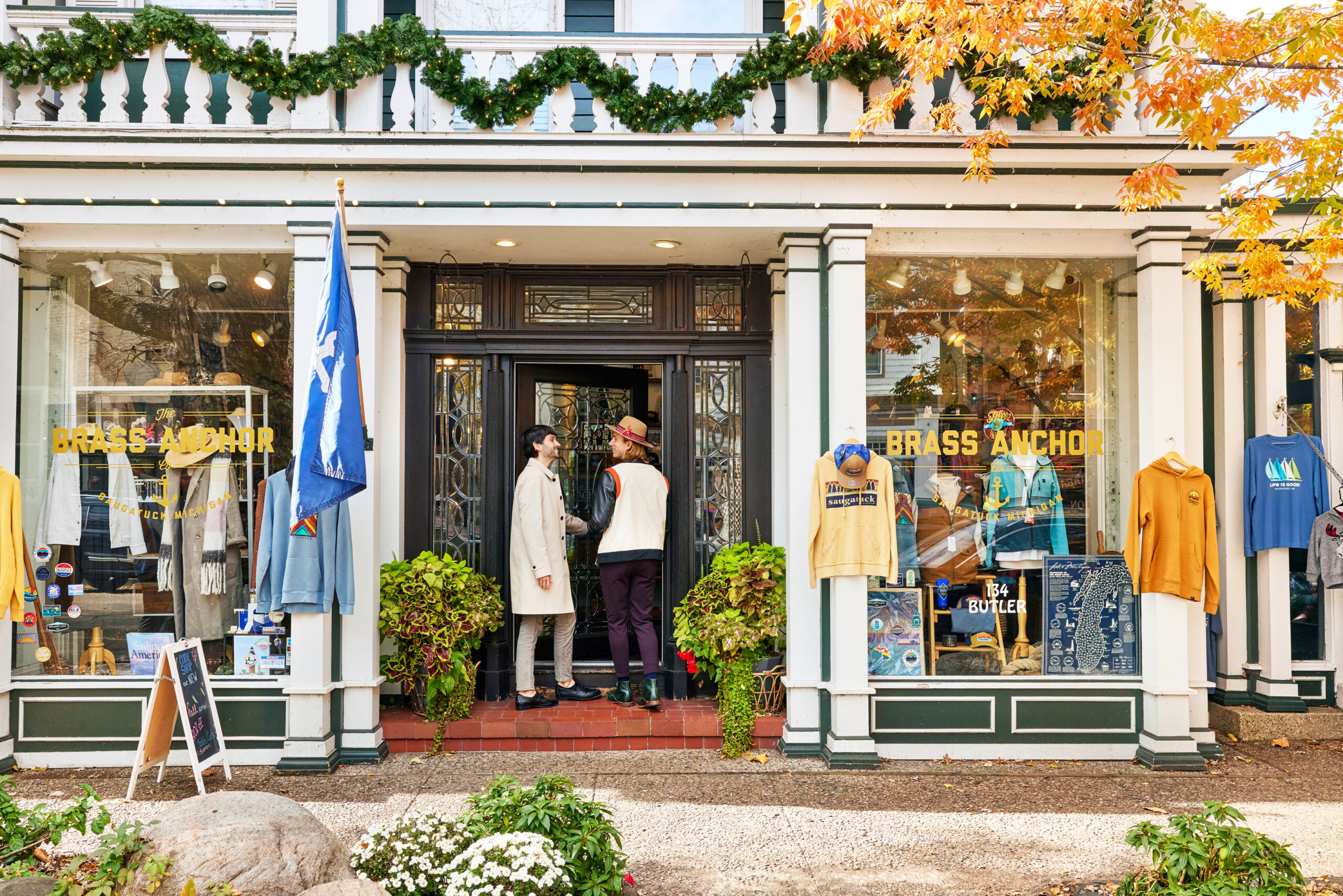 Couple walking inside Brass Anchor in downtown Saugatuck during the fall.